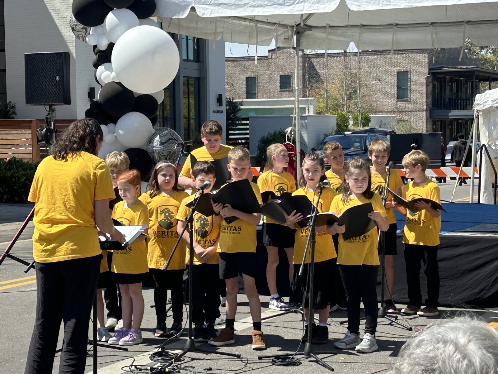 Veritas students singing together at a Fairhope community performance