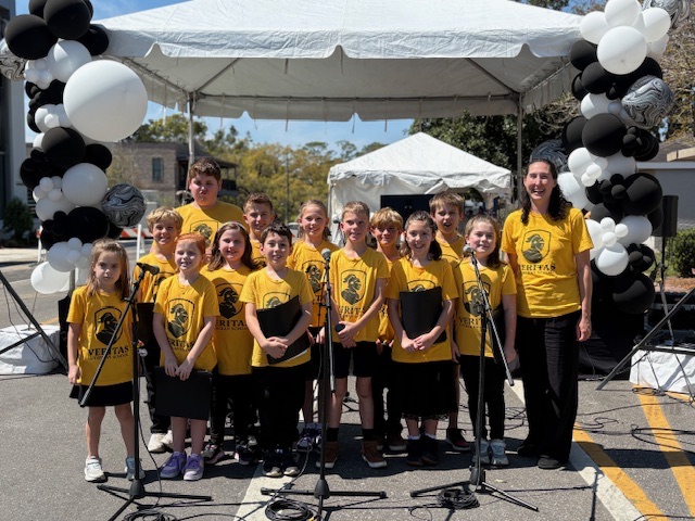 Veritas students representing their school at a community performance