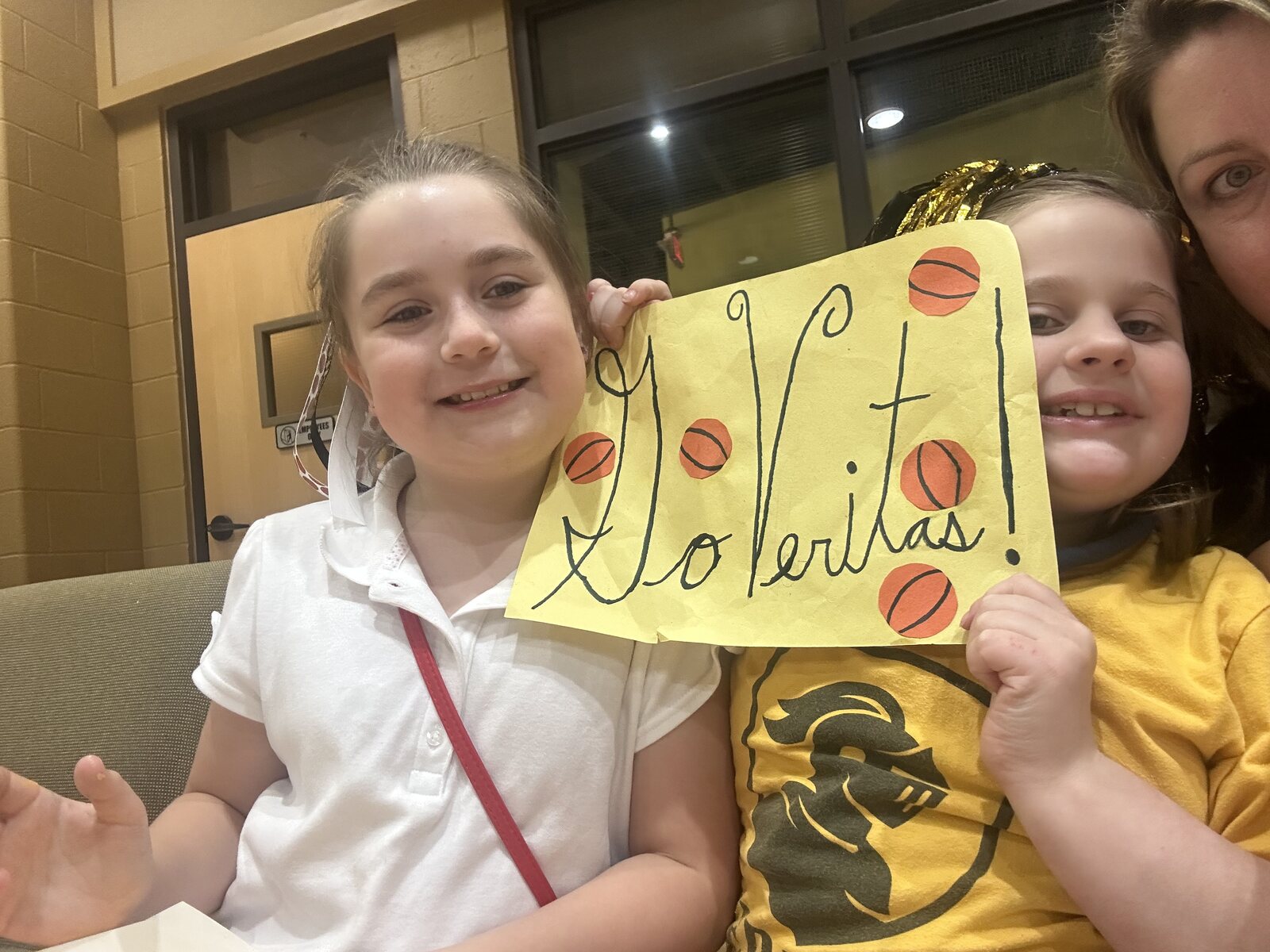 Veritas students holding a hand-lettered Soli Deo Gloria sign